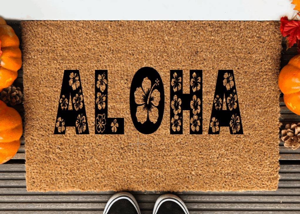 Aloha hand painted doormat, word aloha interspersed with flowers, painted in black on coir doormat